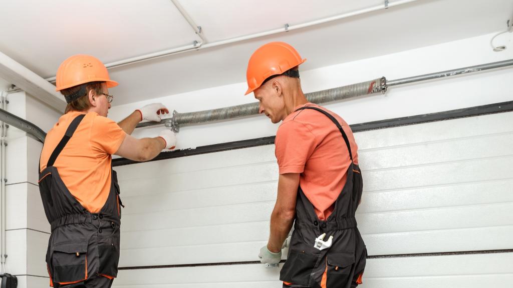Two technicians performing a full garage door repair