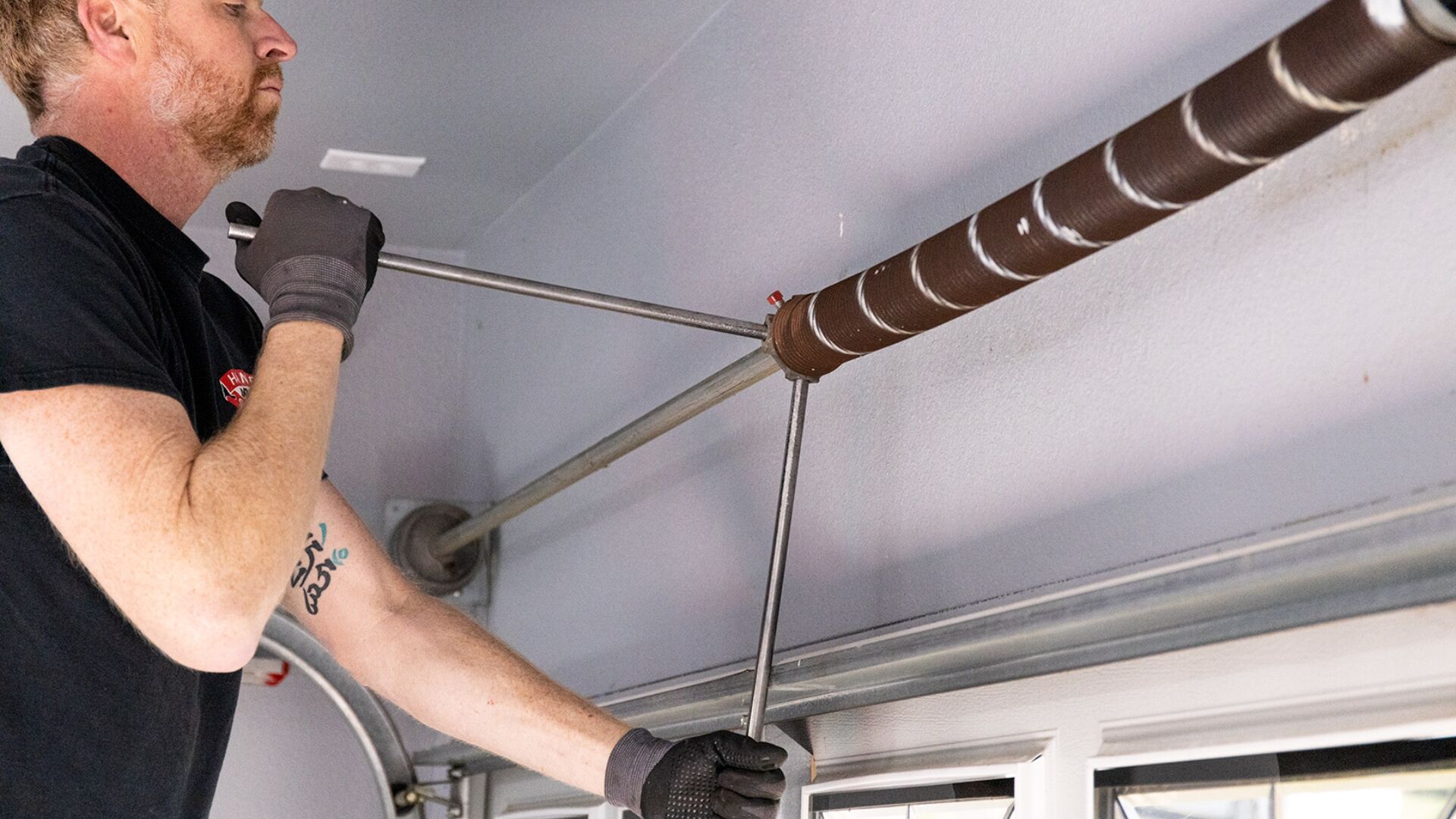 A man fixing unbalanced garage doors