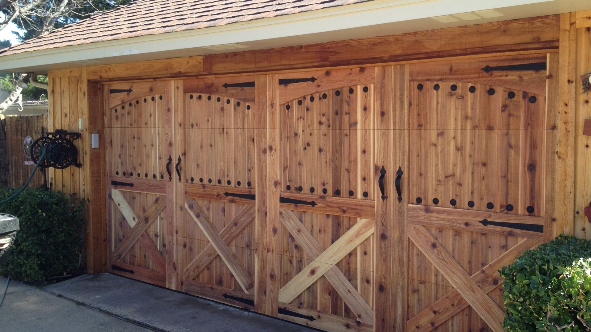 A custom garage door with decorative hardware