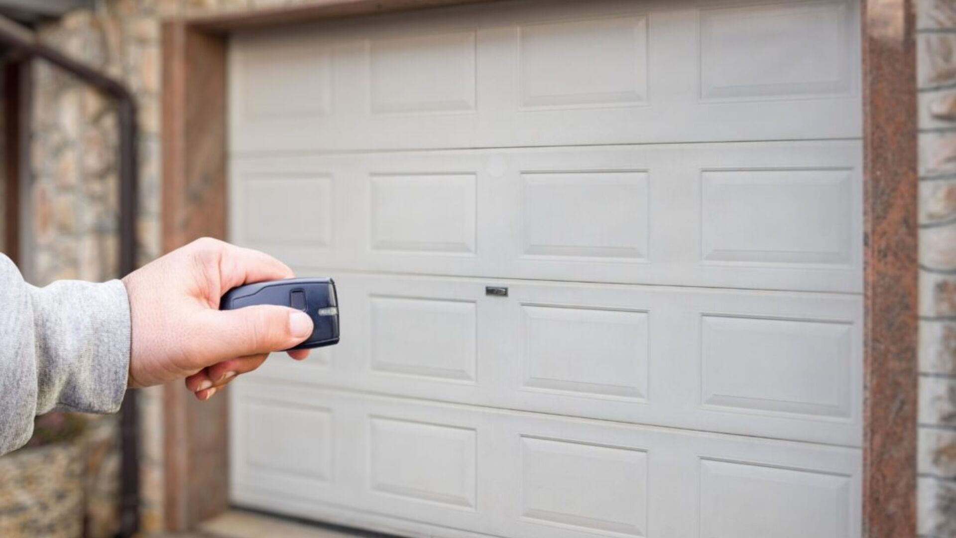 Checking garage door response with remote after annual maintenance.