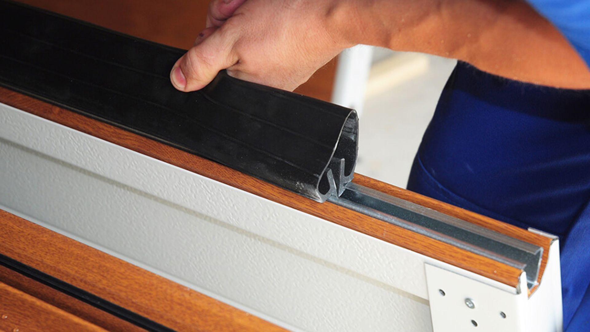 New garage door seal installation to prevent gaps when closing.