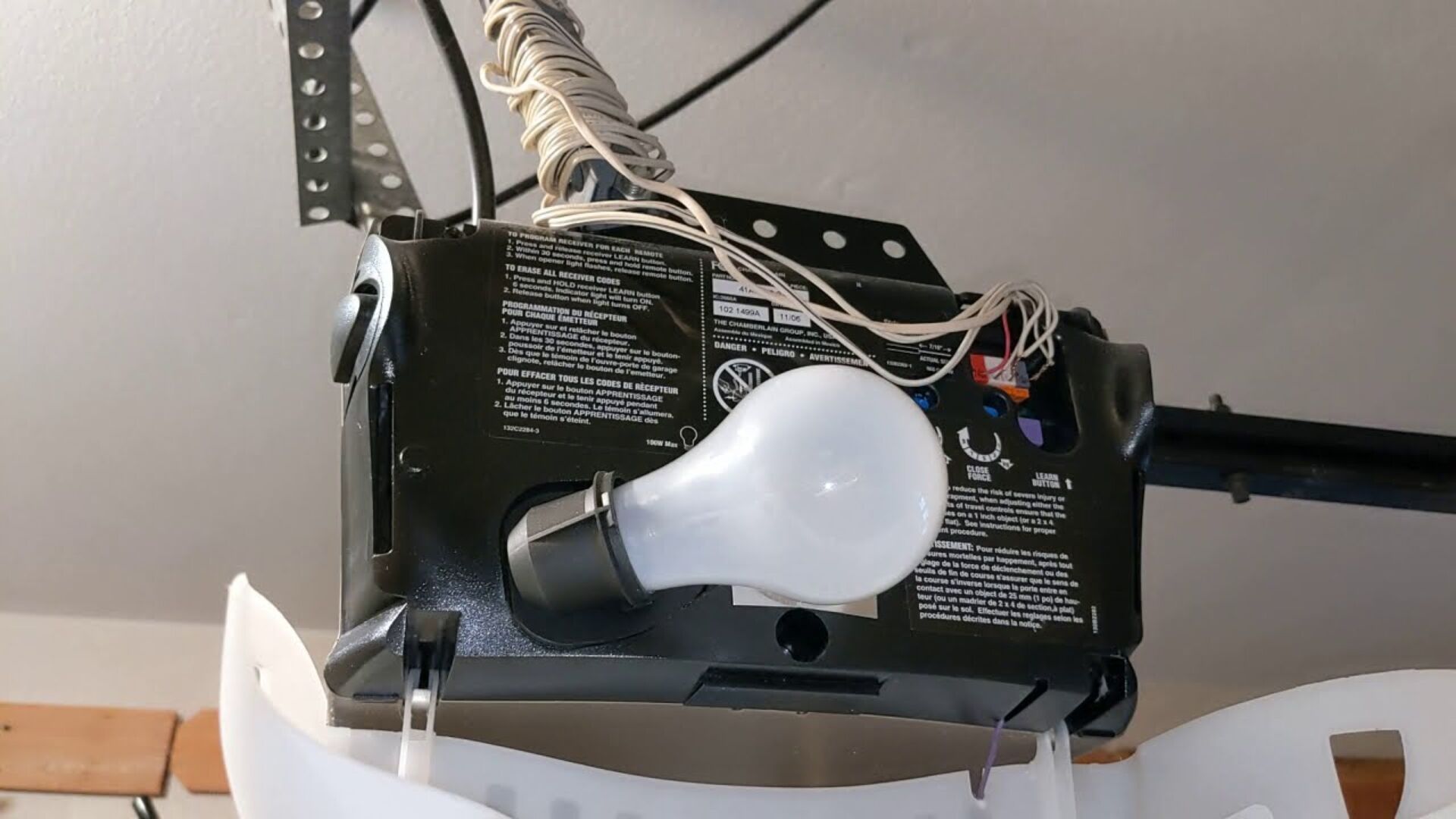 Light bulb installed on a garage door opener unit.