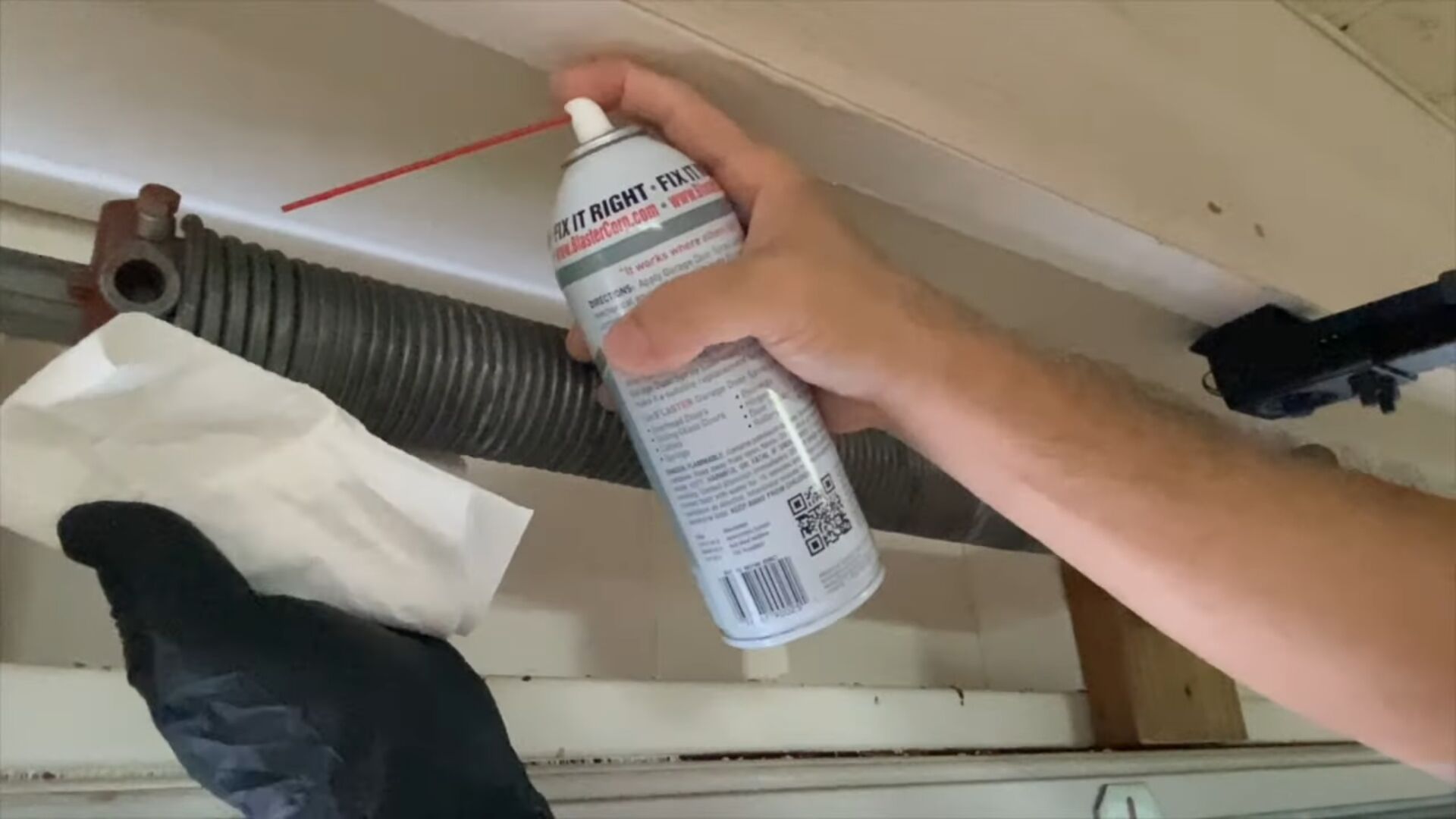 Lubricating a garage door spring to reduce noise and improve operation