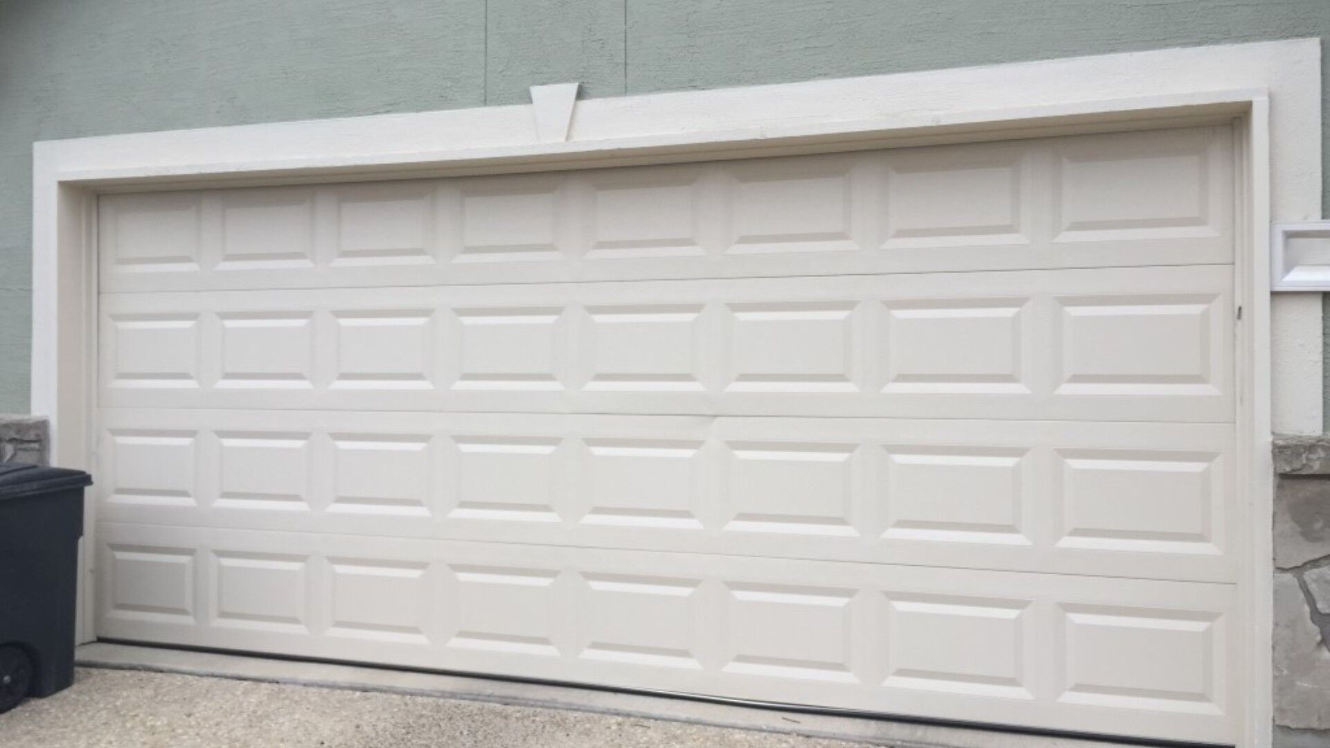 A residential garage door stuck closed due to humidity-related swelling