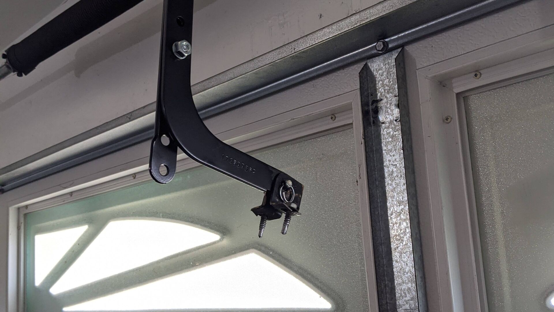 Loose or broken garage door opener bracket causing operational issues