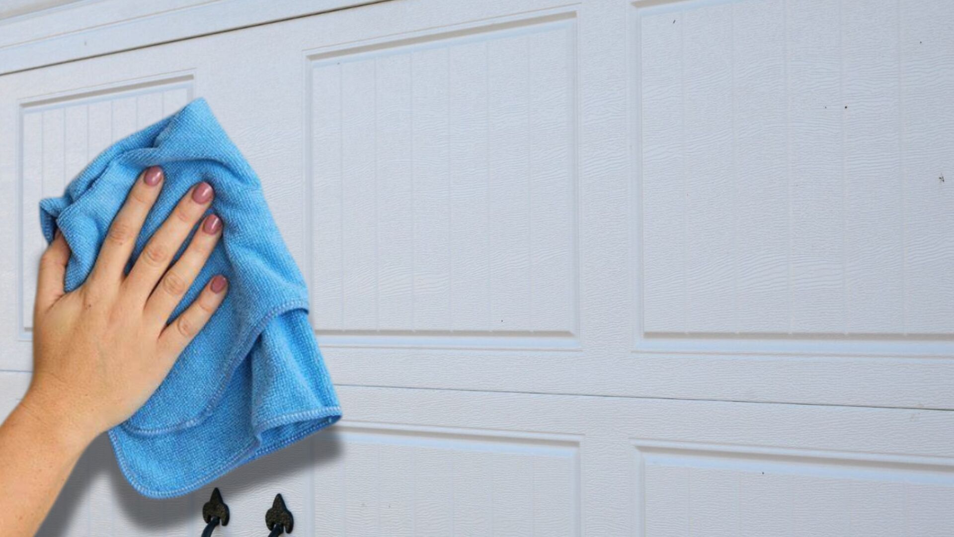 Wiping down a garage door to keep its painted surface clean.